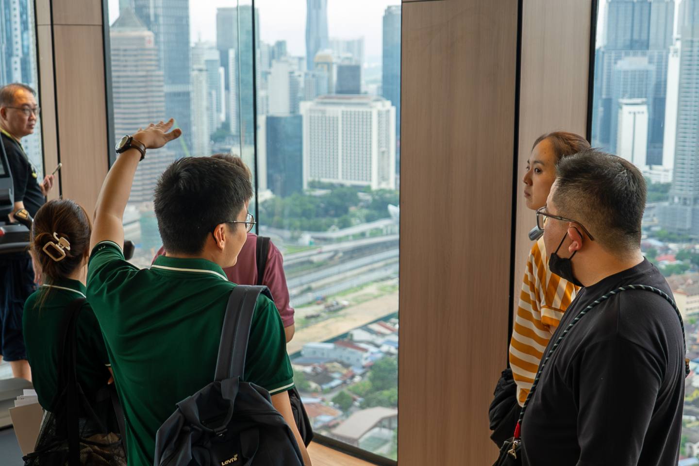 Clients viewing the Kuala Lumpur skyline from a high-floor unit