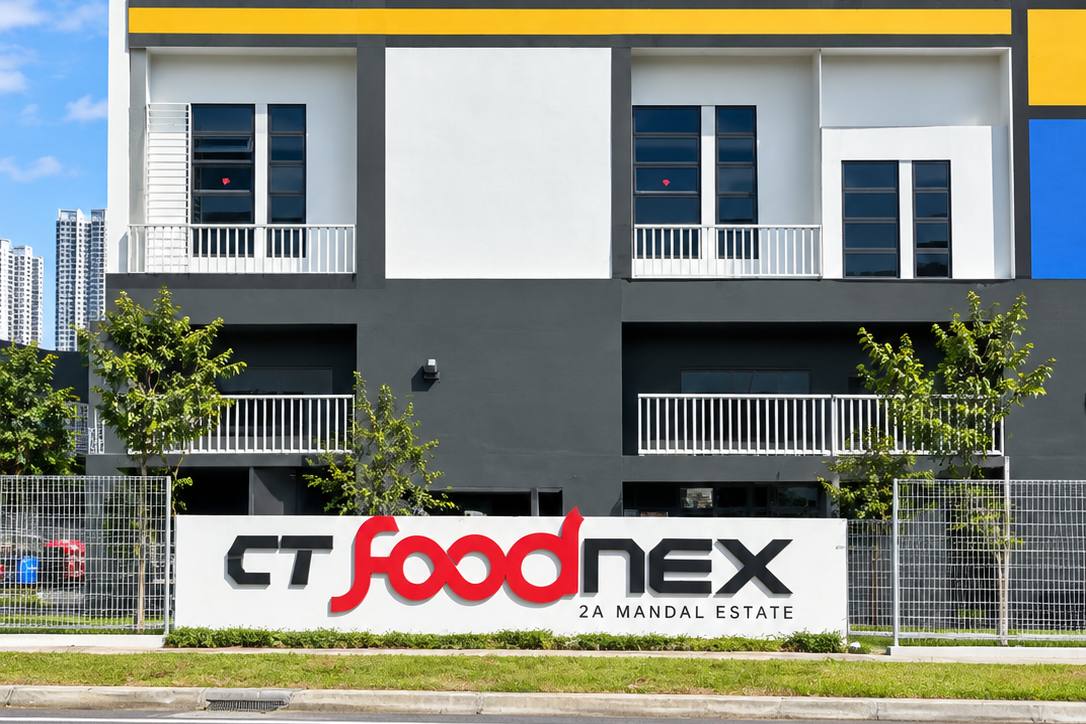 The frontage and signage of CT FoodNex, a multi-storey food factory in Mandai Estate